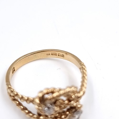 35 - Star Lot : A twist set nine carat gold ring with Diamonds . Size - O, Weight - 2.77 grams.
