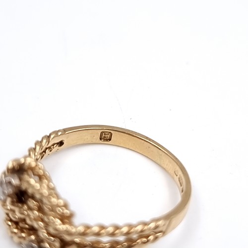 35 - Star Lot : A twist set nine carat gold ring with Diamonds . Size - O, Weight - 2.77 grams.