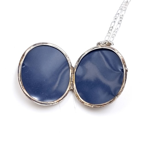 28 - A Sterling Silver large locket pendant and chain with foliate design. Weight - 13 grams.