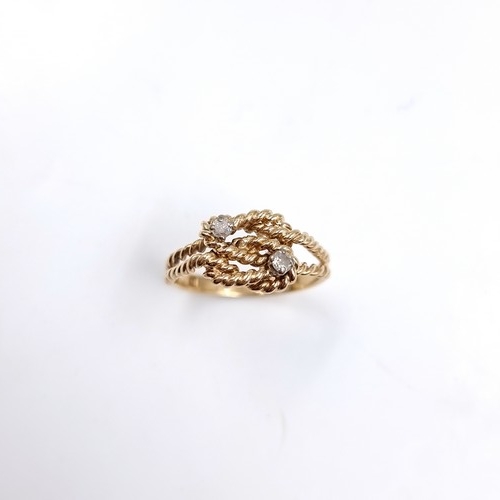 35 - Star Lot : A twist set nine carat gold ring with Diamonds . Size - O, Weight - 2.77 grams.