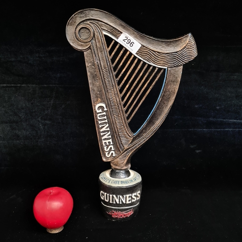 A Guinness branded hand crafted advertising piece in the form of the iconic harp.