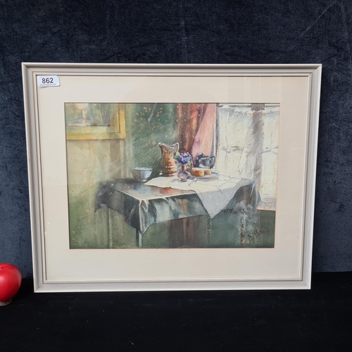 Star Lot: A 'N Welster' watercolour and pencil on paper painting. Features a still life study of an interior space with flowers in a vase, a bread slice on a plate, jug on a table by the window. Characterised by a soft warm glow through the piece. Portrays light and fluid brushstrokes with layered detailing. Rendered in soft ochres, honeyed yellows, gentle rose and peach hues capturing the glow of sunlight filtering through the window. Signed lower right. Housed in a wooden gilt frame behind glass. Slight foxing to piece portraying age.