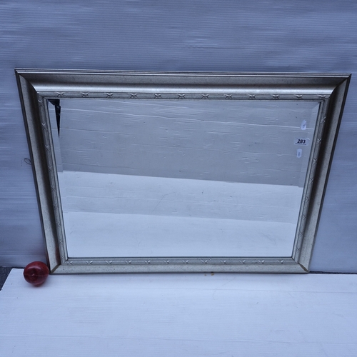 A stylish large contemporary beveled wall mirror. In a sleek brushed gilt frame.