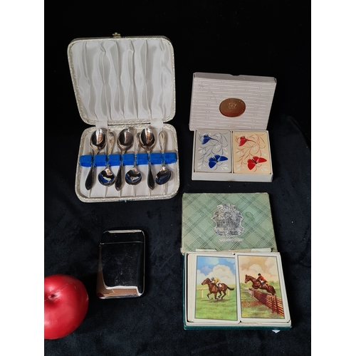 A mixed lot comprised of two vintage sets of playing cards, a boxed set ...