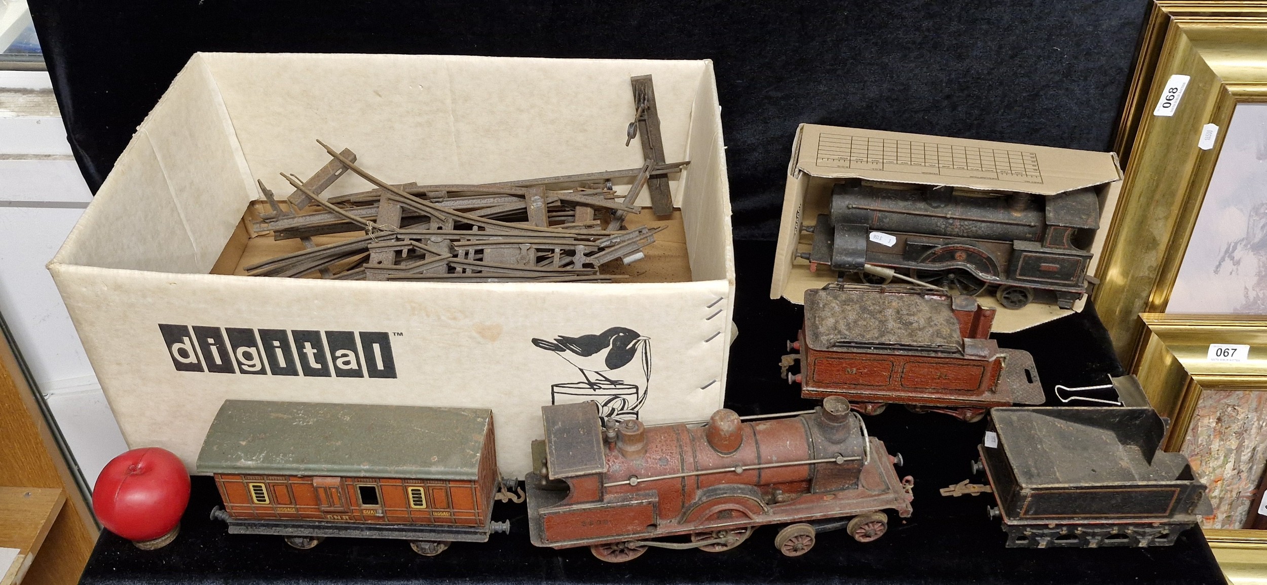 An antique collection of cast metal railways trains and tracks. Shows ...