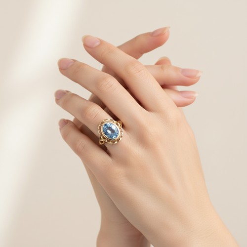 7 - Star Lot: A pretty Blue Topaz floral designed ring set in nine carat gold. Size  - L, Weight - 2.7 g... 