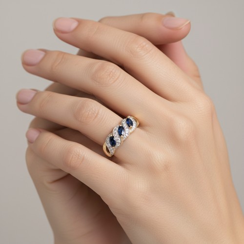 9 - Star Lot: A fine three stone Sapphire and Diamond gemstone cluster ring set in nine carat gold. Size... 