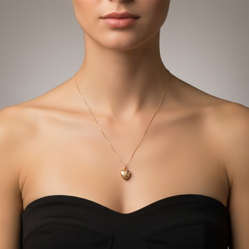 22 - A pretty nine carat gold heart shaped pendant and chain set in nine carat gold. Weight - 1.28 grams.... 