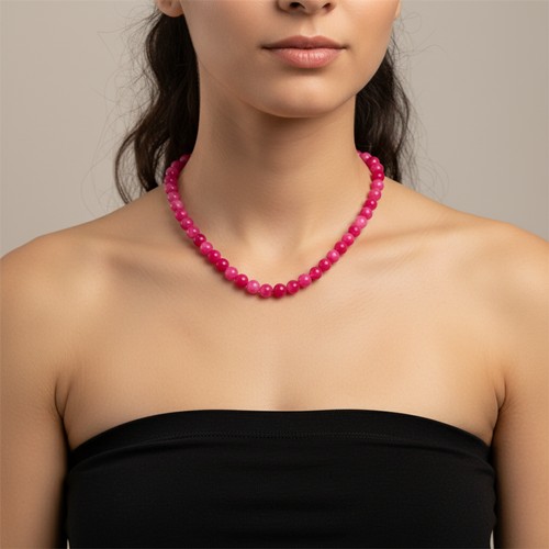 28 - A vibrant Pink Gemstone necklace. Weight - 43.4 grams. Stones cold to the touch. Please note, the im... 