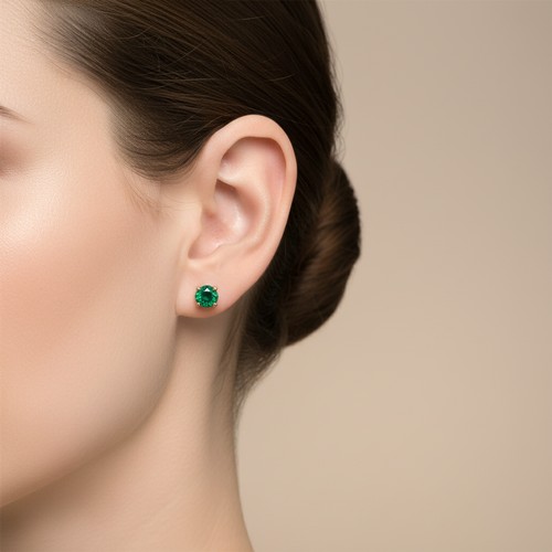 21 - Star Lot : A pair of nine carat gold Emerald stud earrings with 10 carat gold backs. Please note, th... 