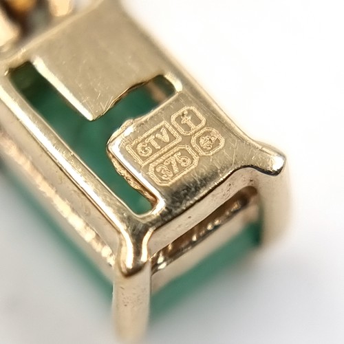 23 - A five Emerald gemstone pendant necklace set in nine carat gold. Weight - 1.75 grams. Please note, t... 