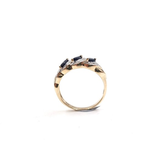 9 - Star Lot: A fine three stone Sapphire and Diamond gemstone cluster ring set in nine carat gold. Size... 