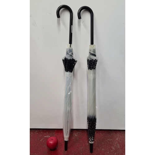 123 - Two fine tall transparent umbrellas, in good order.