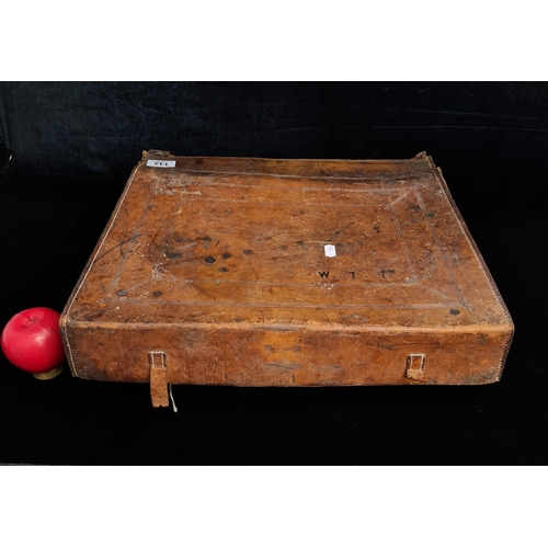 132 - An antique leather bound book case. Initialed W.T.T to top. In need of repair.
Could it Be the portf... 