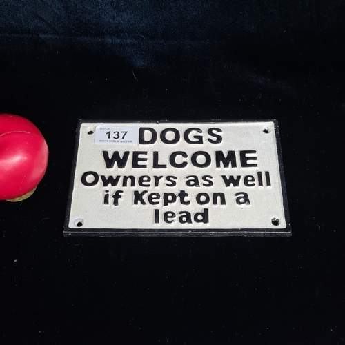 137 - A humorous wall mounted cast metal sign reading 