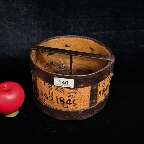 140 - A fascinating early 19th century wooden and wrought iron grain measure. With several stamped dates d... 
