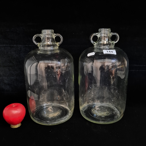 144 - Two large glass Demijohn bottles. Both in excellent condition.
Please note, the image of the modelle... 