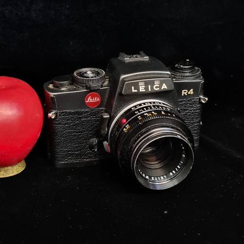 154 - Star Lot: A Leitz Leica R4 35mm film SLR camera fitted with a Summicron R 1:2/50 lens. RRP €859.