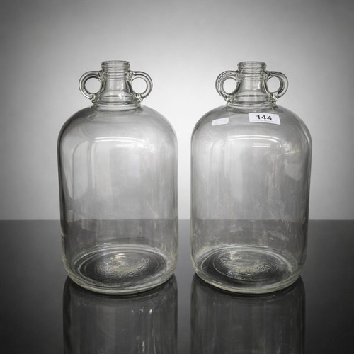 144 - Two large glass Demijohn bottles. Both in excellent condition.
Please note, the image of the modelle... 