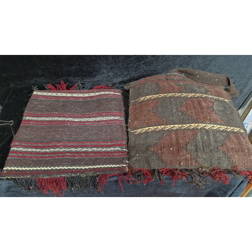 215 - A fascinating hand knotted antique Moroccan camel saddle blanket repurposed into two cushion covers.