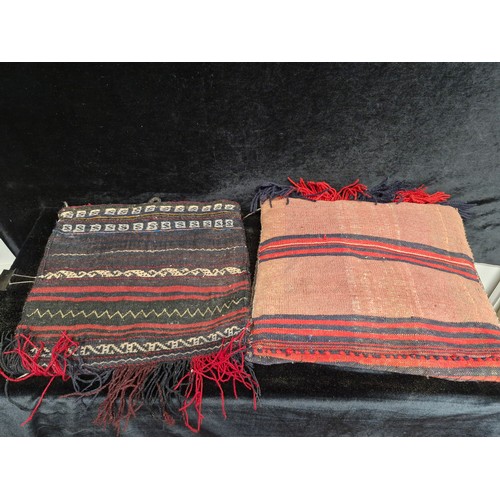 240 - A fascinating hand knotted antique Moroccan camel saddle blanket repurposed into two cushion covers.