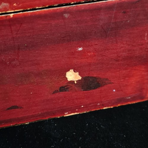 94 - A Japanese lacquered wooden storage box with hand painted gilt accents depicting traditional natures... 