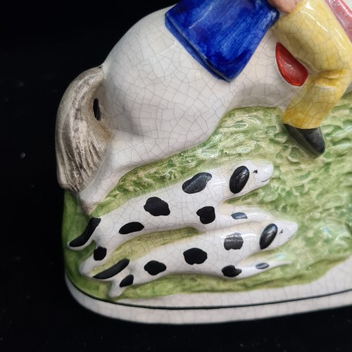 153 - An English 19th century Staffordshire pottery figure depicting a hunter on horseback with hunting do... 