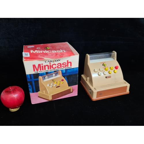 208 - A vintage Casdon Minicash toy cash register. Houses in original box. Please note, the image of the m... 