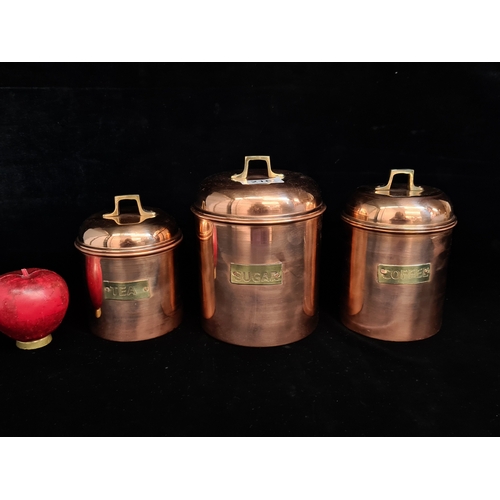 216 - A set of three graduated brass and copper lidded canisters for tea, sugar and coffee. Please note, t... 