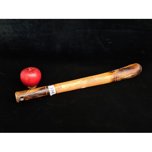 234 - A hand carved wooden ash baton inscribed 'Defence Rapido'. Please note, the image of the modelled it... 