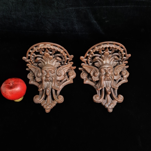 240 - A good pair of heavy cast metal decorative wall sconces. Please note, the image of the modelled item... 