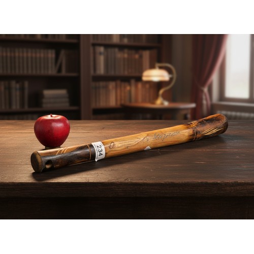 234 - A hand carved wooden ash baton inscribed 'Defence Rapido'. Please note, the image of the modelled it... 