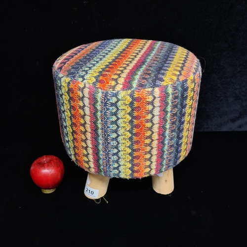 A highly vibrant foot stool with a geometric stripe pattern. Please ...