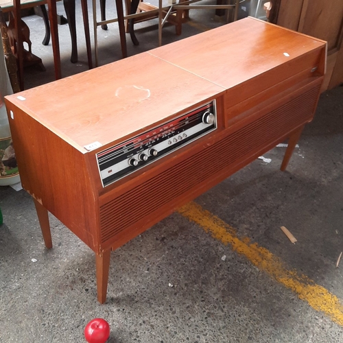 A Falcon radiogram, the rectangular case raised on tapering legs, with ...