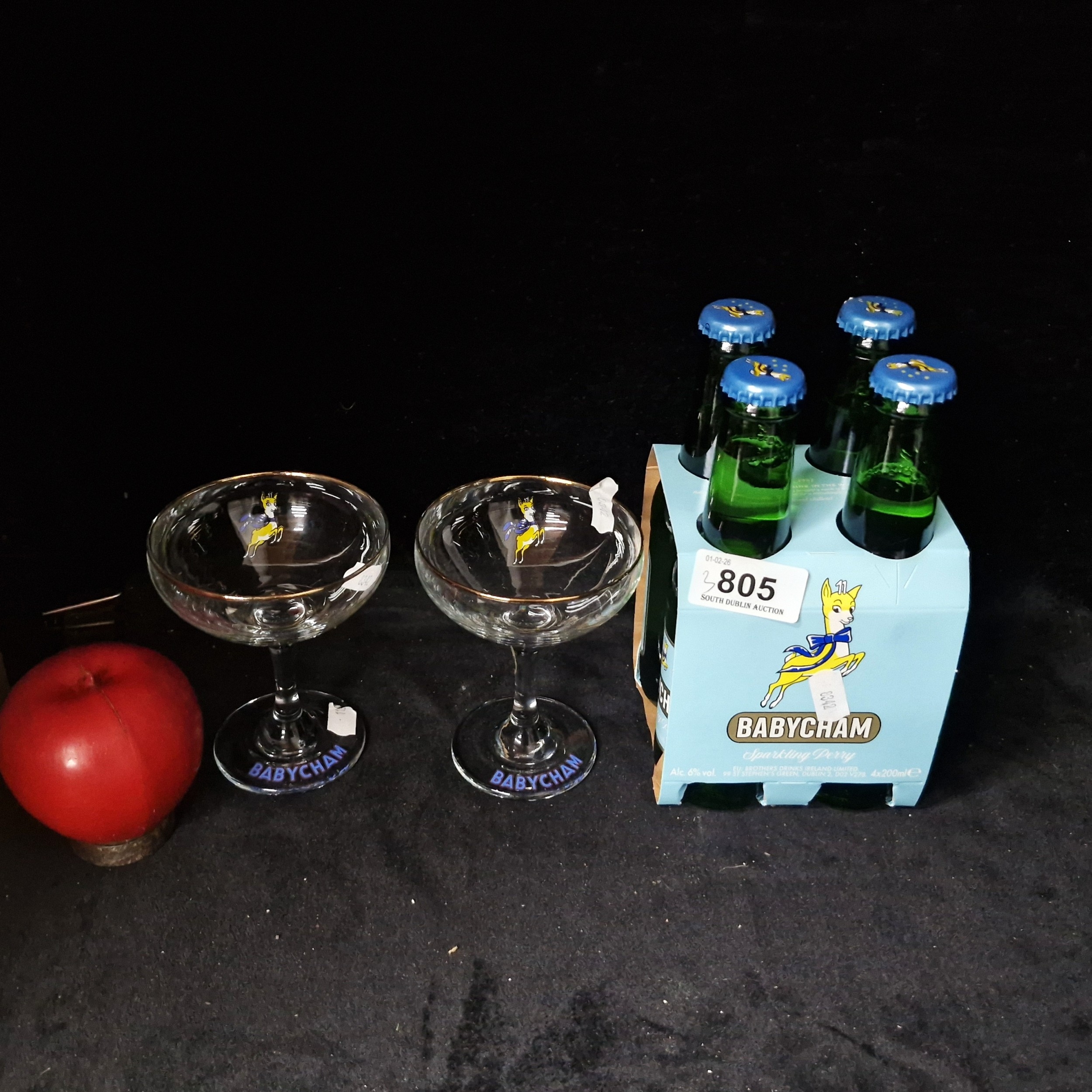 Four sealed bottles of Babycham sparkling perry, along with a pair of ...