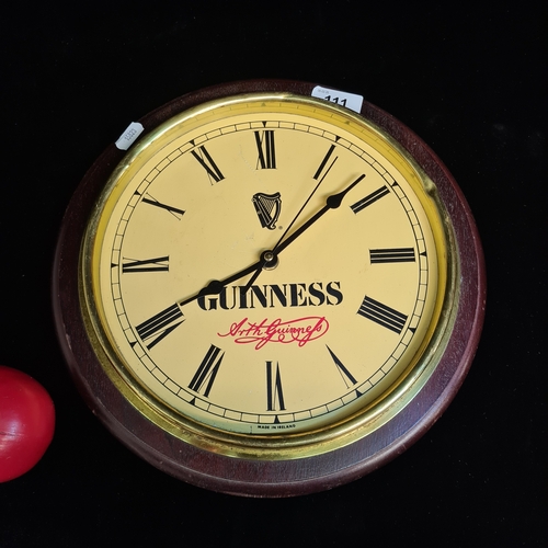 111 - A 'Guinness' branded Petersen clock with wooden back. Not glazed. Please note, the image of the mode... 
