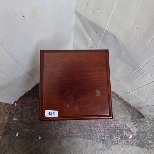 426 - A square-top mahogany pedestal flower pot stand, the moulded top on a fluted column and stepped squa... 
