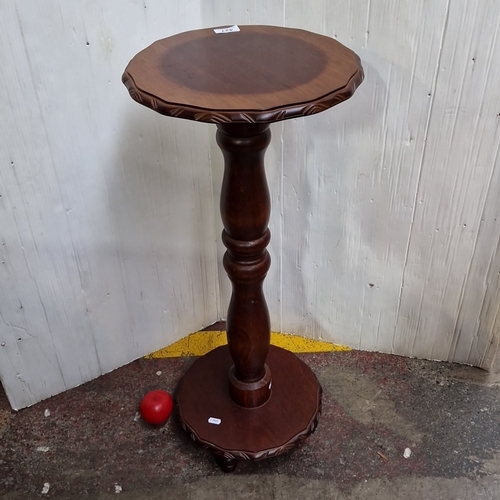 427 - A carved hardwood pedestal occasional table, the circular top and base with leaf-moulded gadrooned e... 