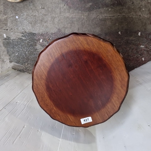 427 - A carved hardwood pedestal occasional table, the circular top and base with leaf-moulded gadrooned e... 