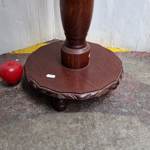 427 - A carved hardwood pedestal occasional table, the circular top and base with leaf-moulded gadrooned e... 