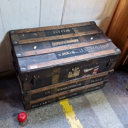 434 - Star Lot : An antique canvas-covered  travelling trunk with timber battens and brass studding, iron ... 