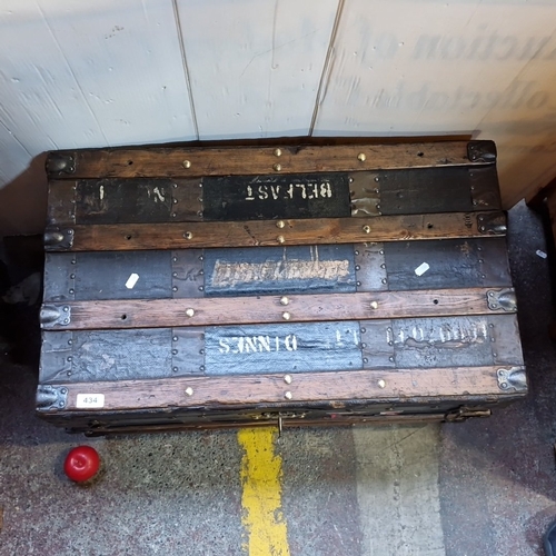 434 - Star Lot : An antique canvas-covered  travelling trunk with timber battens and brass studding, iron ... 