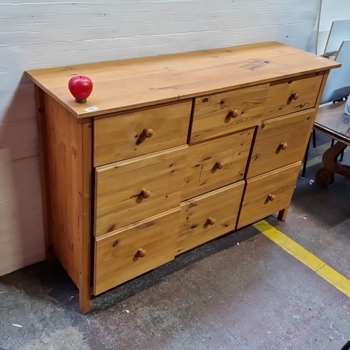 437 - A pine chest of nine drawers, the facade arranged with graduated drawers fitted with turned wooden k... 