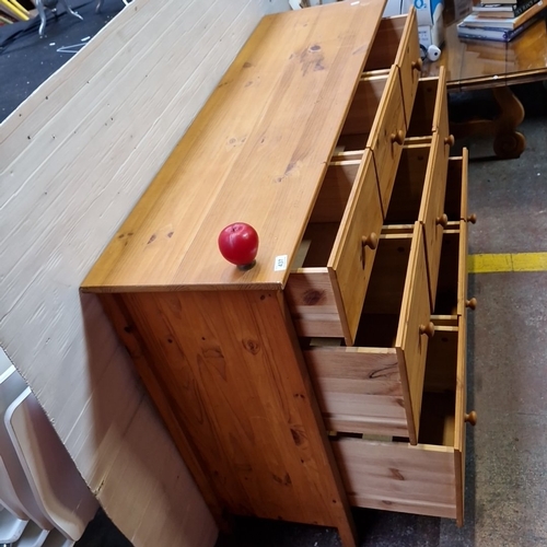 437 - A pine chest of nine drawers, the facade arranged with graduated drawers fitted with turned wooden k... 