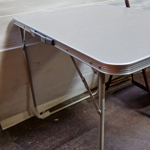 438 - Set of 2: a folding rectangular table with grey top and tubular metal frame, together with a two-ste... 
