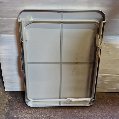 438 - Set of 2: a folding rectangular table with grey top and tubular metal frame, together with a two-ste... 