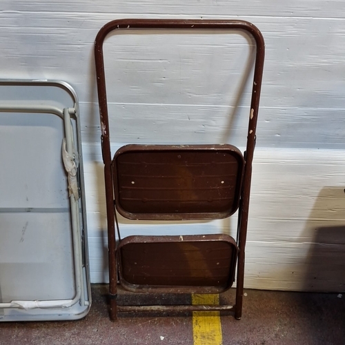 438 - Set of 2: a folding rectangular table with grey top and tubular metal frame, together with a two-ste... 