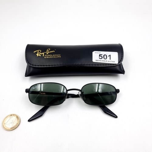 501 - A pair of Ray Ban sunglasses with black metal frames. Lens in good condition. Comes in original leat... 