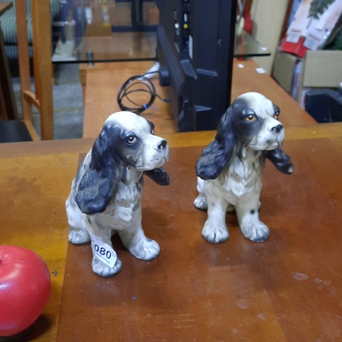 1080 - Pair of German porcelain modelled spaniel dogs, seated and naturalistically painted in grey and whit... 