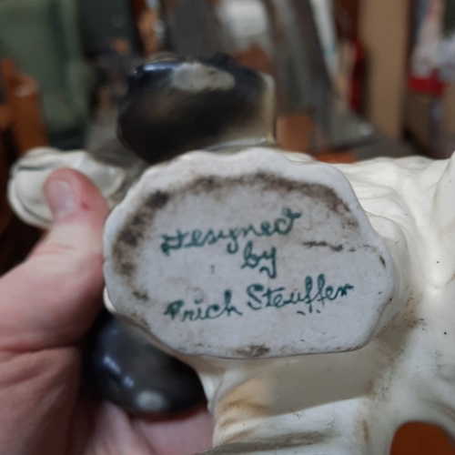 1080 - Pair of German porcelain modelled spaniel dogs, seated and naturalistically painted in grey and whit... 